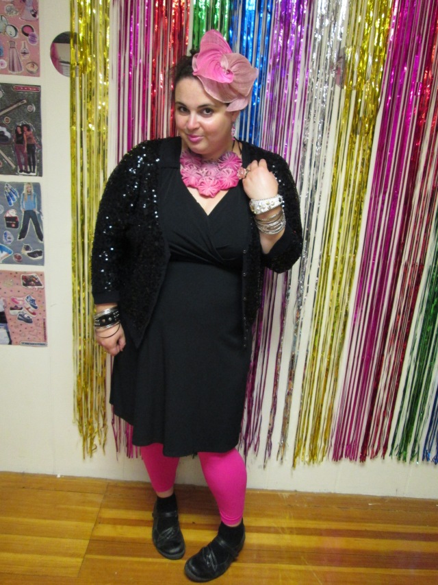plus size  black outfit with pink leggings, necklace, fascinator, and earrings