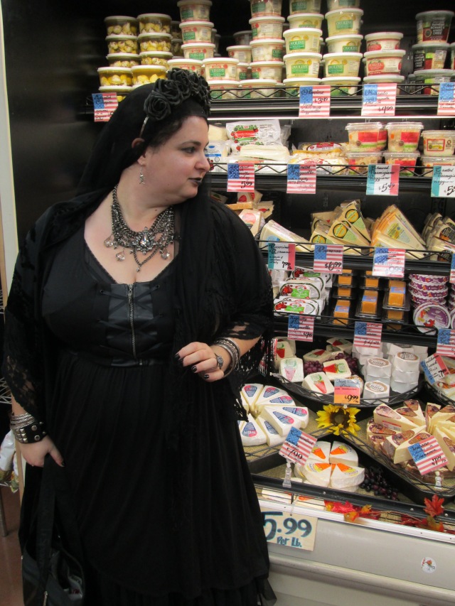 goth queen surveying cheese in trader joe's
