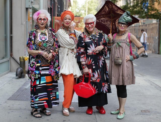 group of fashionable older women wearing bright colors and accessories