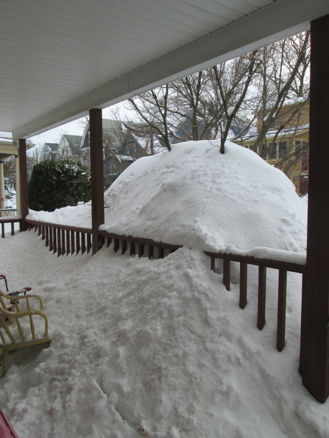 porch covered in piles of snow, nearly up to the second floor