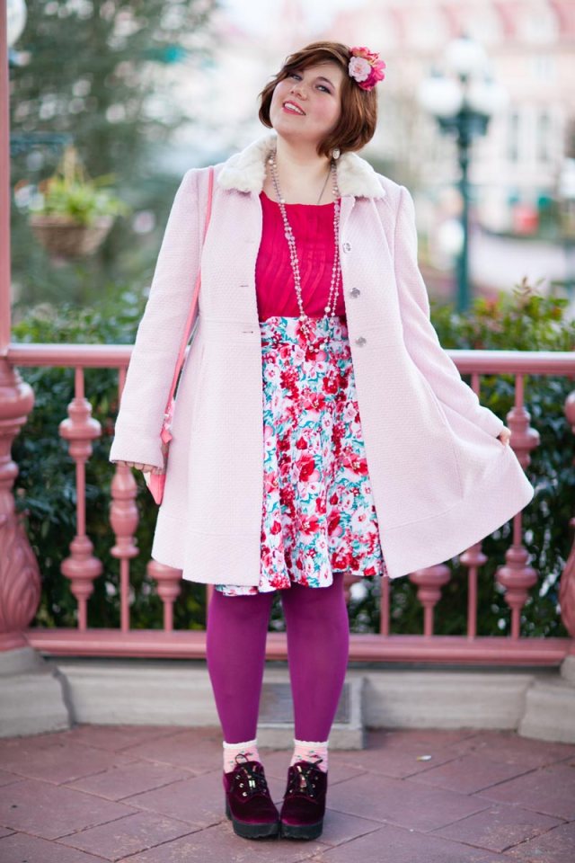 plus size outfit light pink coat, red top, floral skirt, purple tights, hair flower